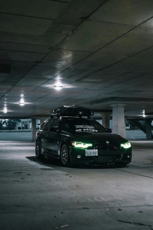 a black car parked in a parking garage