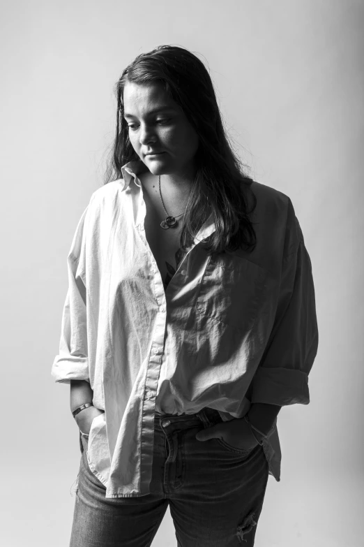 a woman standing in black and white with her hands on her hips