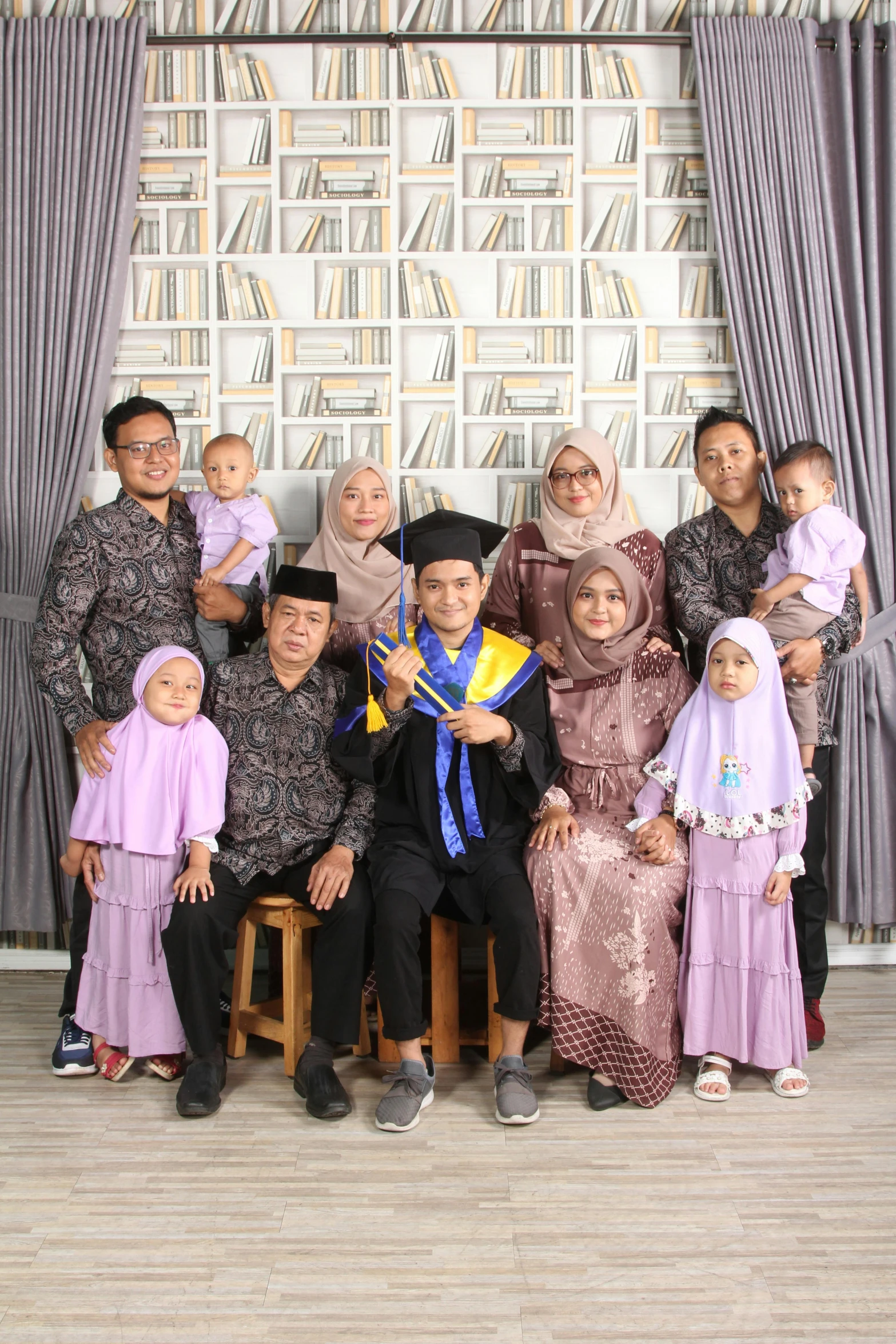 a family poses for a picture in the studio