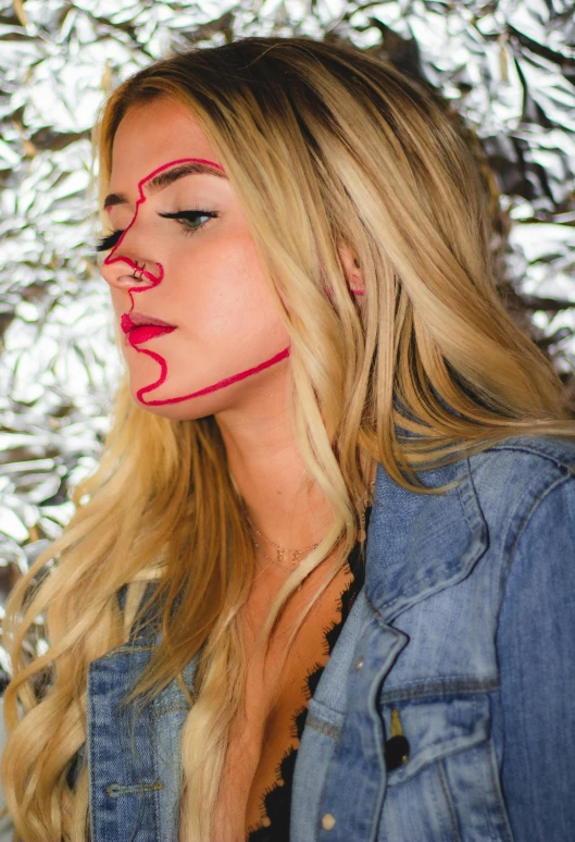 a woman wearing pink and red lips with a piercing