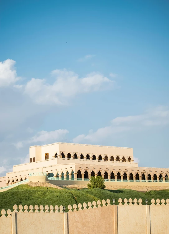 a castle building sits on top of a hill