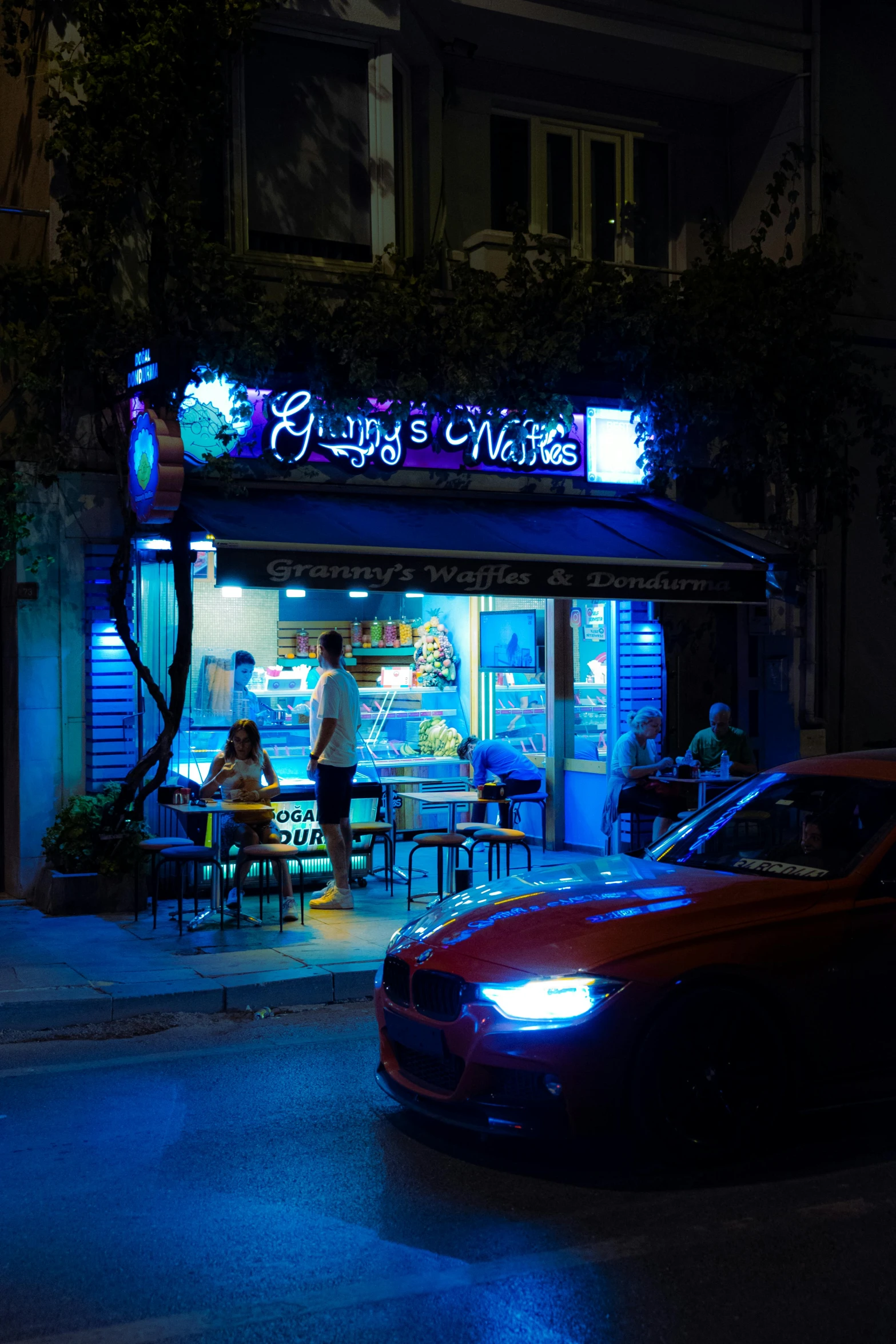 a car parked in front of a restaurant