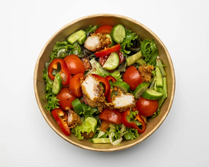 a bowl filled with salad with meat and vegetables