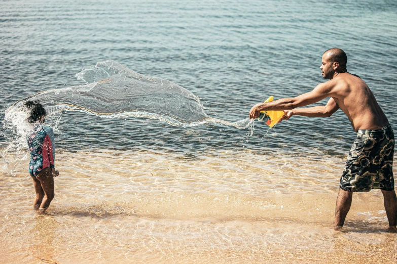 a man flying a kite while a  watches