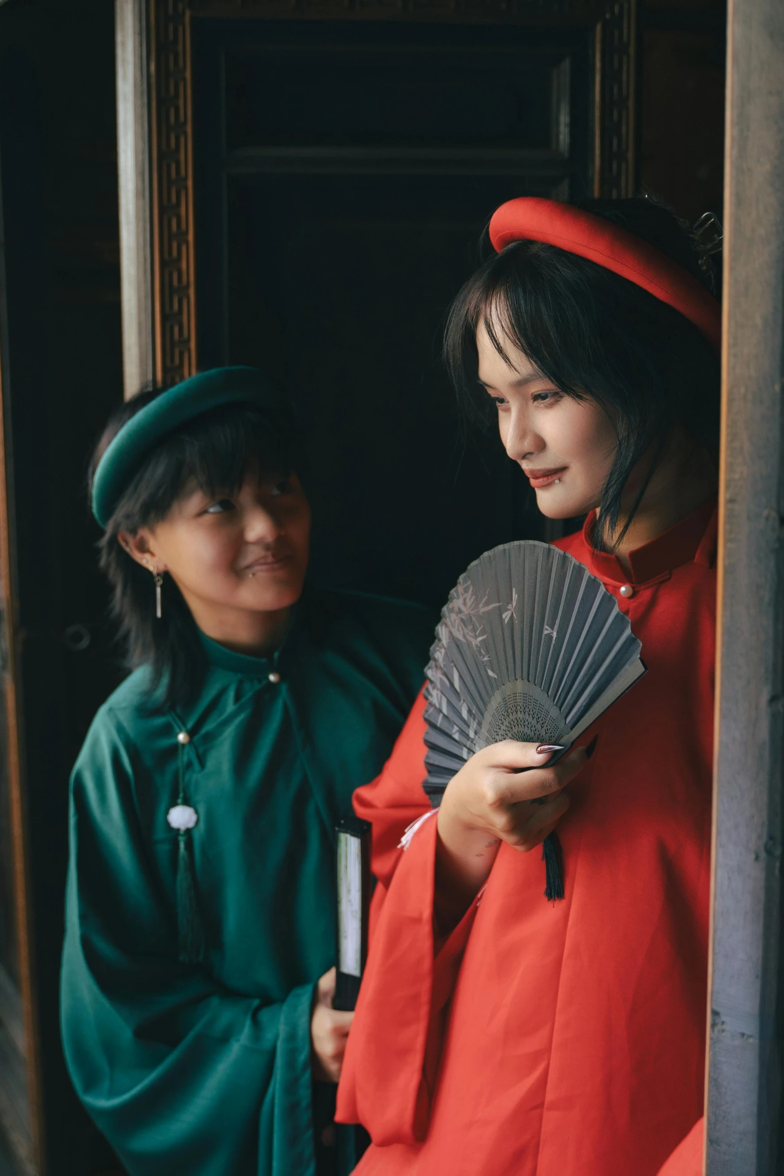 a woman is holding a fan in her hand