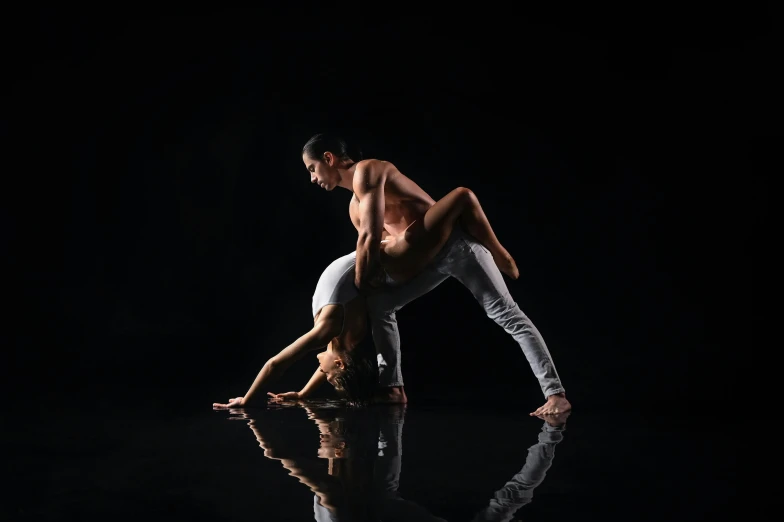 a shirtless man standing in the middle of a dance pose