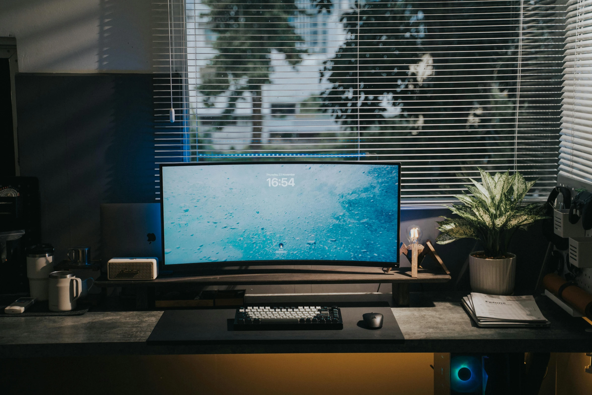 a desk with a laptop computer and keyboard