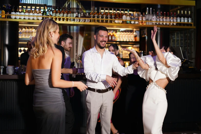 a man and a woman dancing with each other at a party