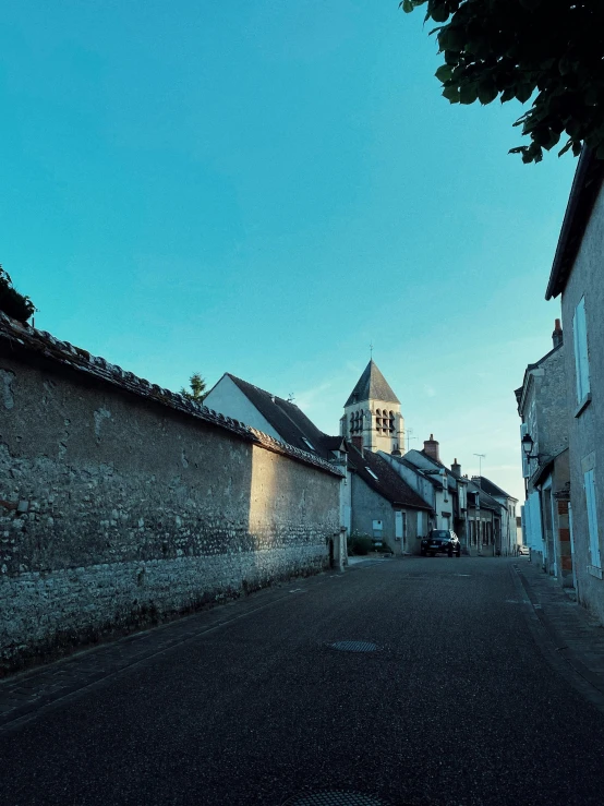 an empty road with a building in the background