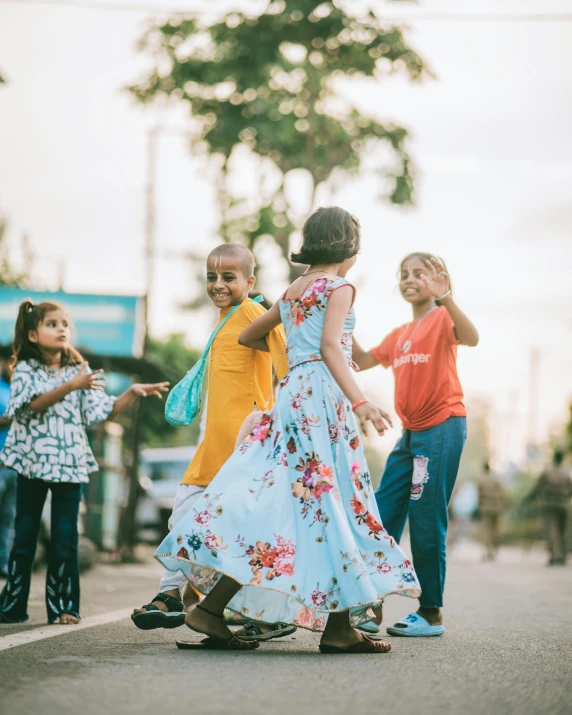 children dressed in colorful clothing standing in street