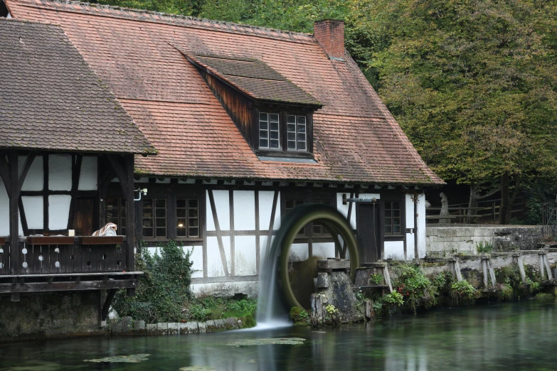 an old village is surrounded by a waterfall