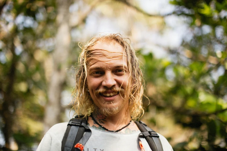 man with beard, mustache and beard piercings smiling