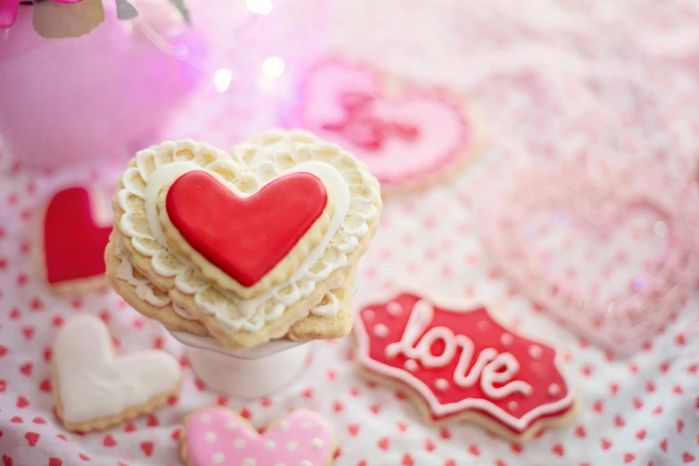 heart shaped cookies and cookies next to the table