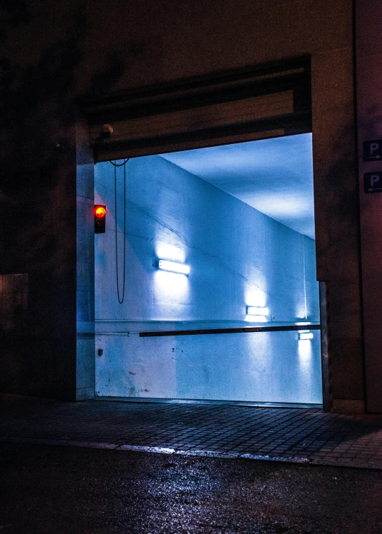 a blue light shining through an open door