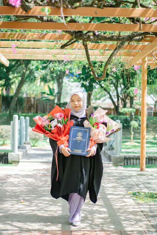 a woman walking down a street while holding a bunch of flowers