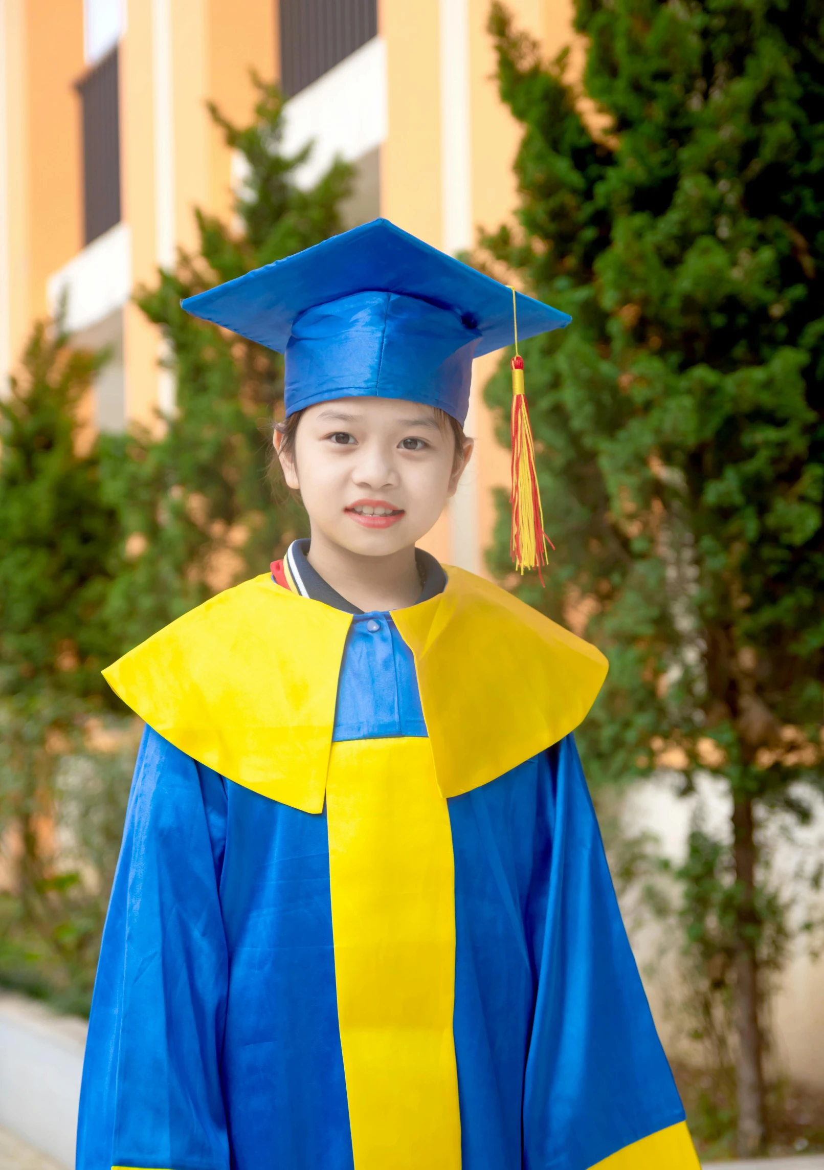 a child in a graduation gown posing for a po