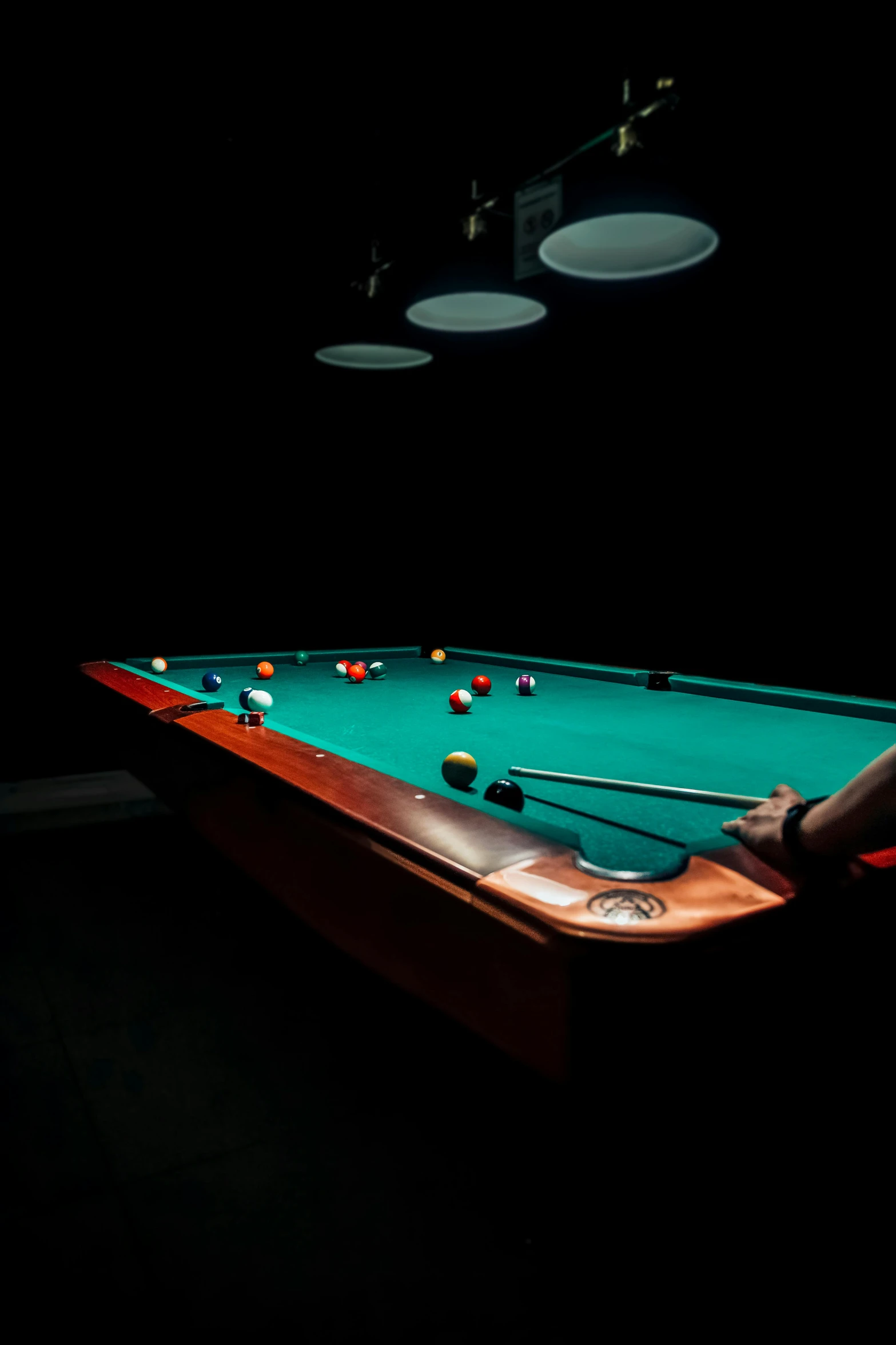 a pool table and cues are sitting on it