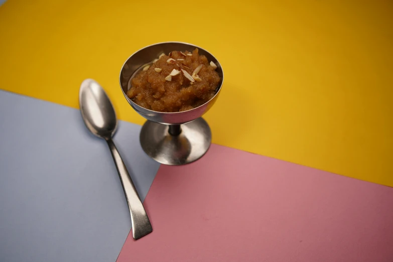 there is food in this metal cup on the table