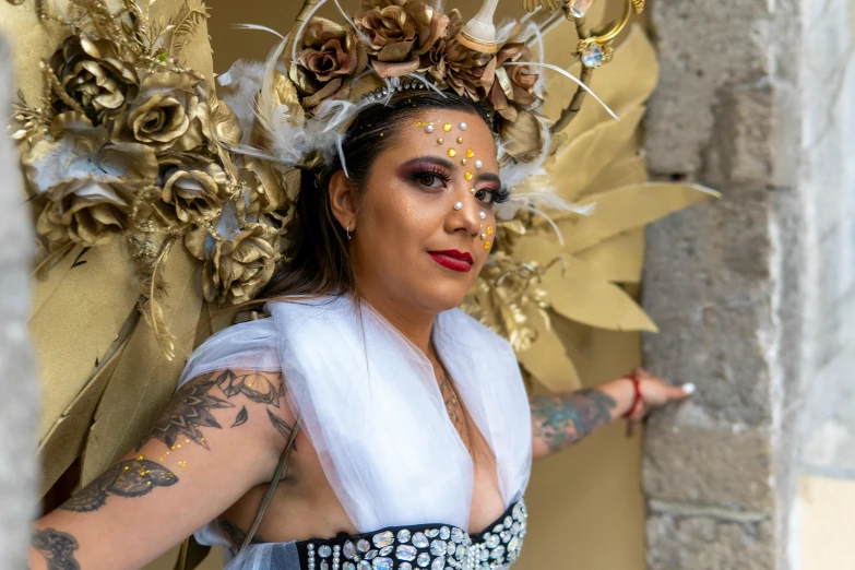 woman in costume pointing at soing while wearing a head piece