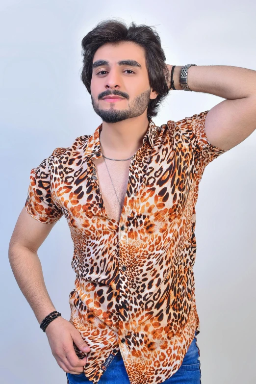 man wearing an orange leopard print shirt