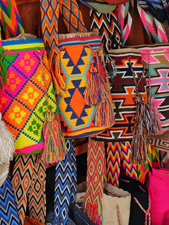 a collection of brightly colored baskets and bags