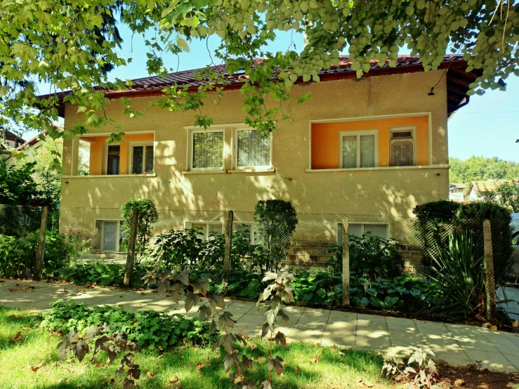 a brown and orange house with trees around