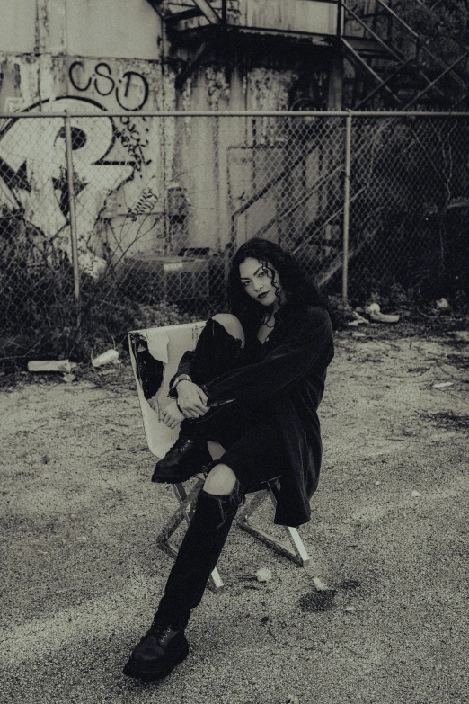 a woman and a cow sitting by a fence