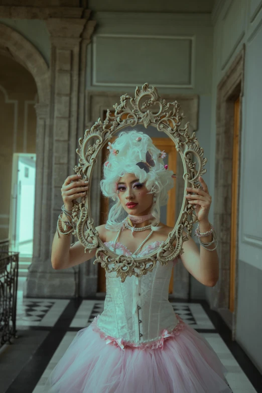 a woman dressed up as a princess holding a mirror