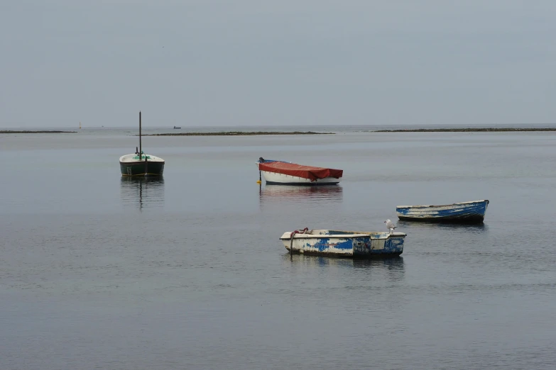 three boats floating on the water near each other