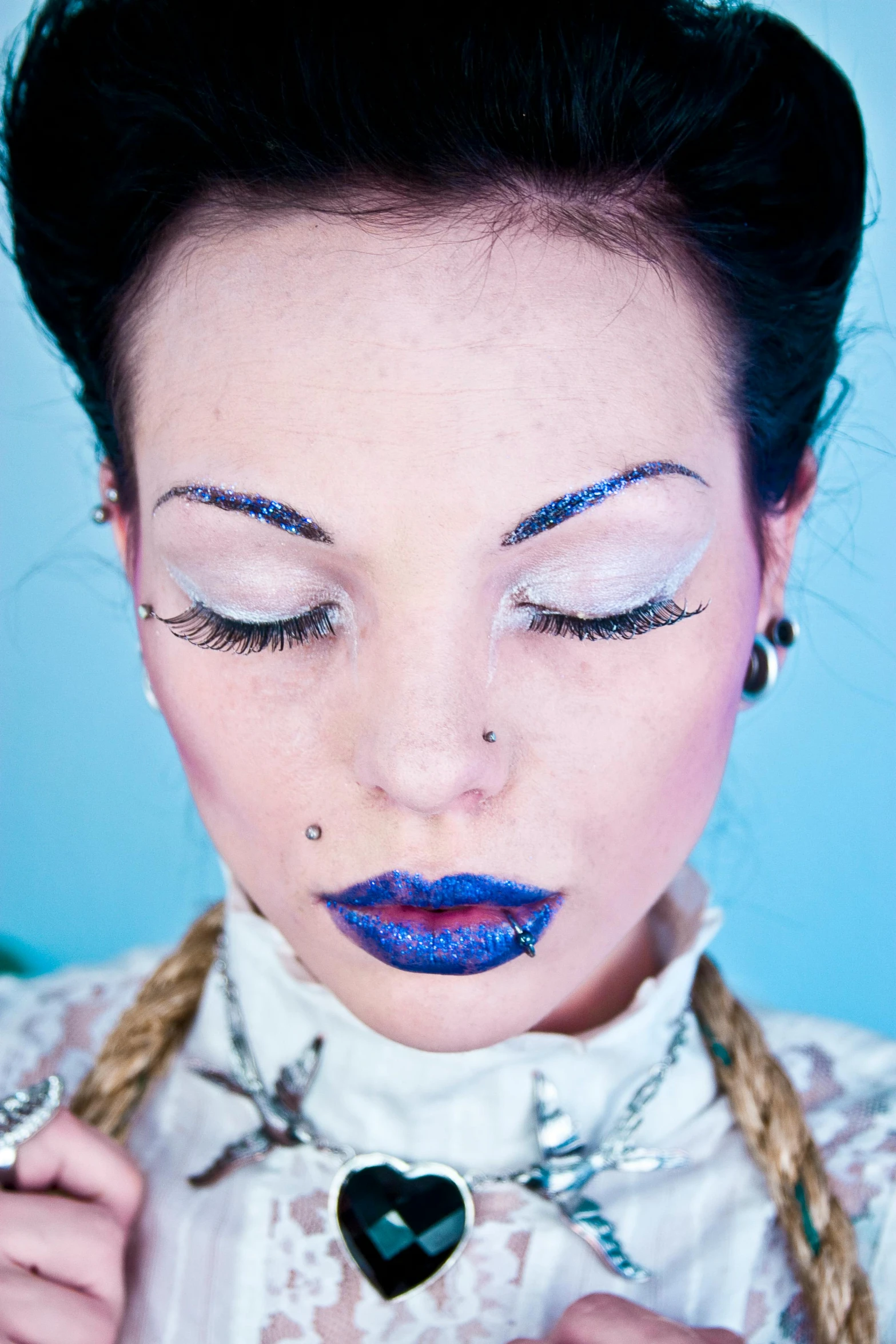 a woman wearing blue lipstick and a white shirt