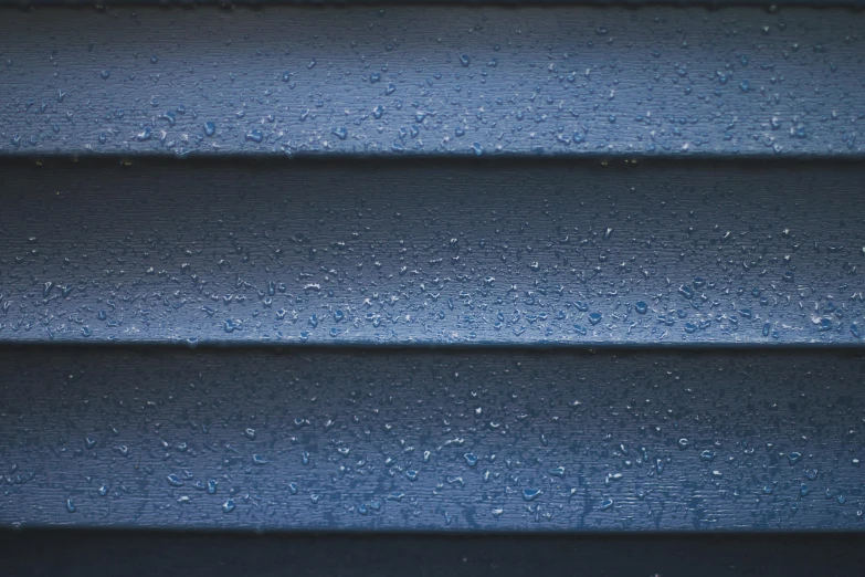 a closeup of a wall with rain drops on it