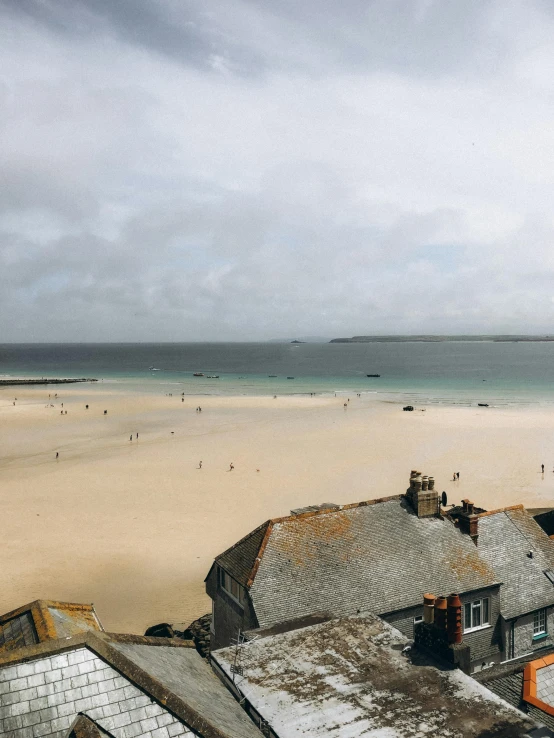 looking down on a beach from the roof of an apartment building