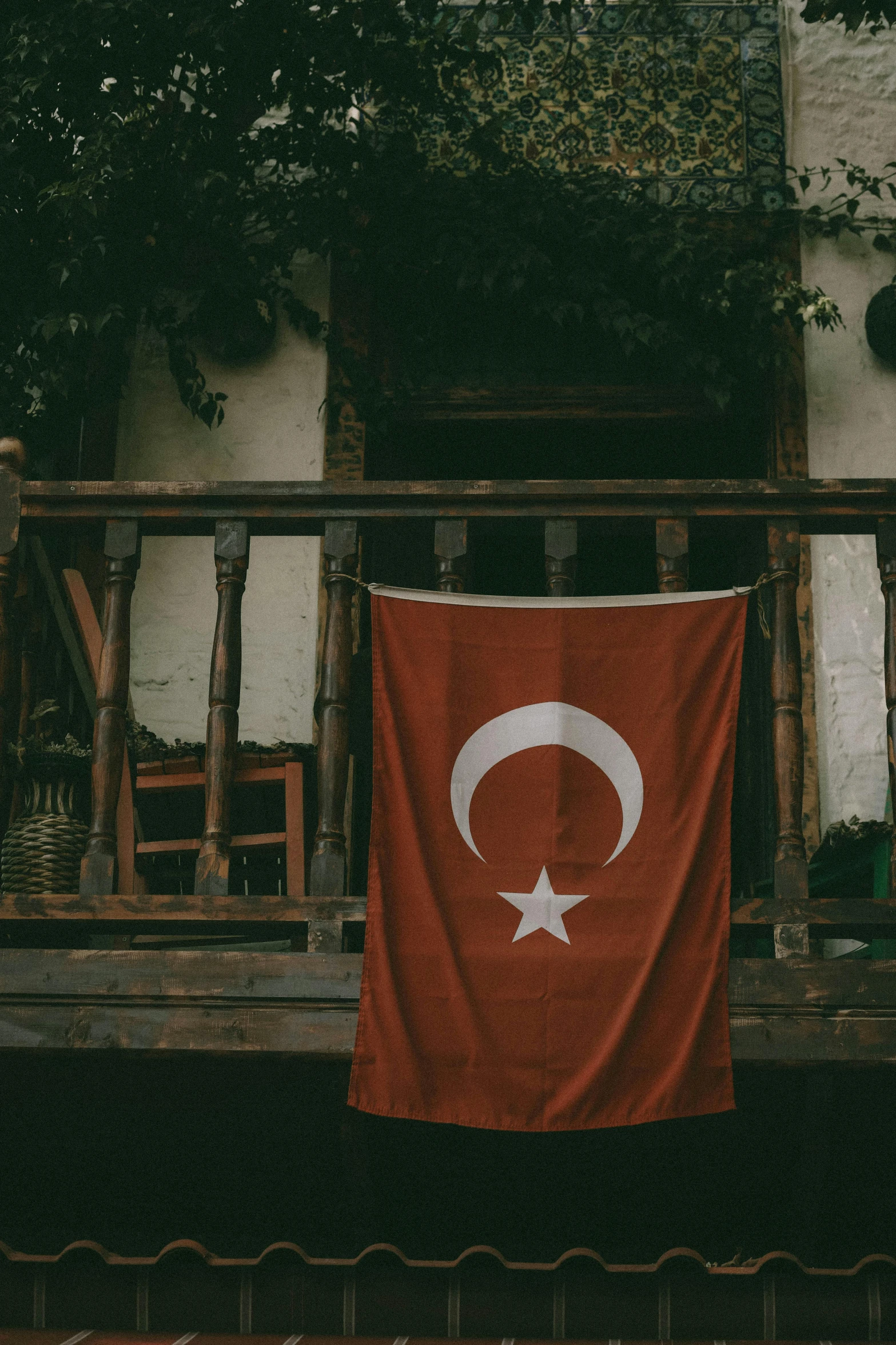 a red and white turkish flag hangs on the balcony