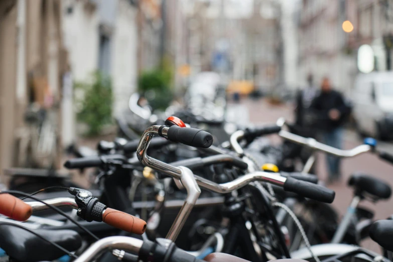 a row of bikes and other bicycles parked on the side of a road