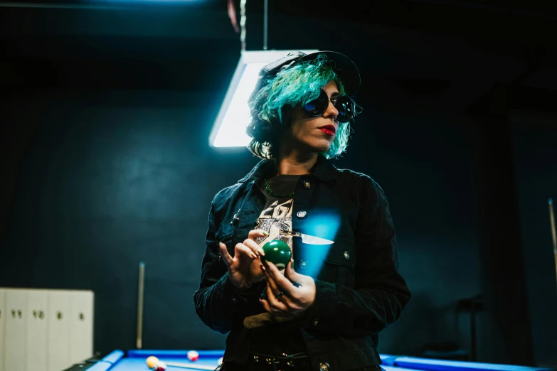 a woman with dyed hair in an indoor pool room