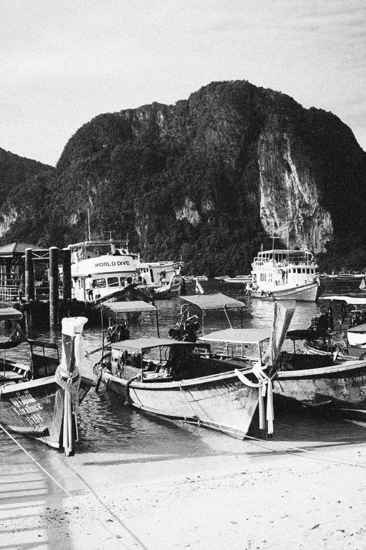 several boats are docked in an old black and white po