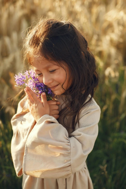 a  standing in front of tall grass