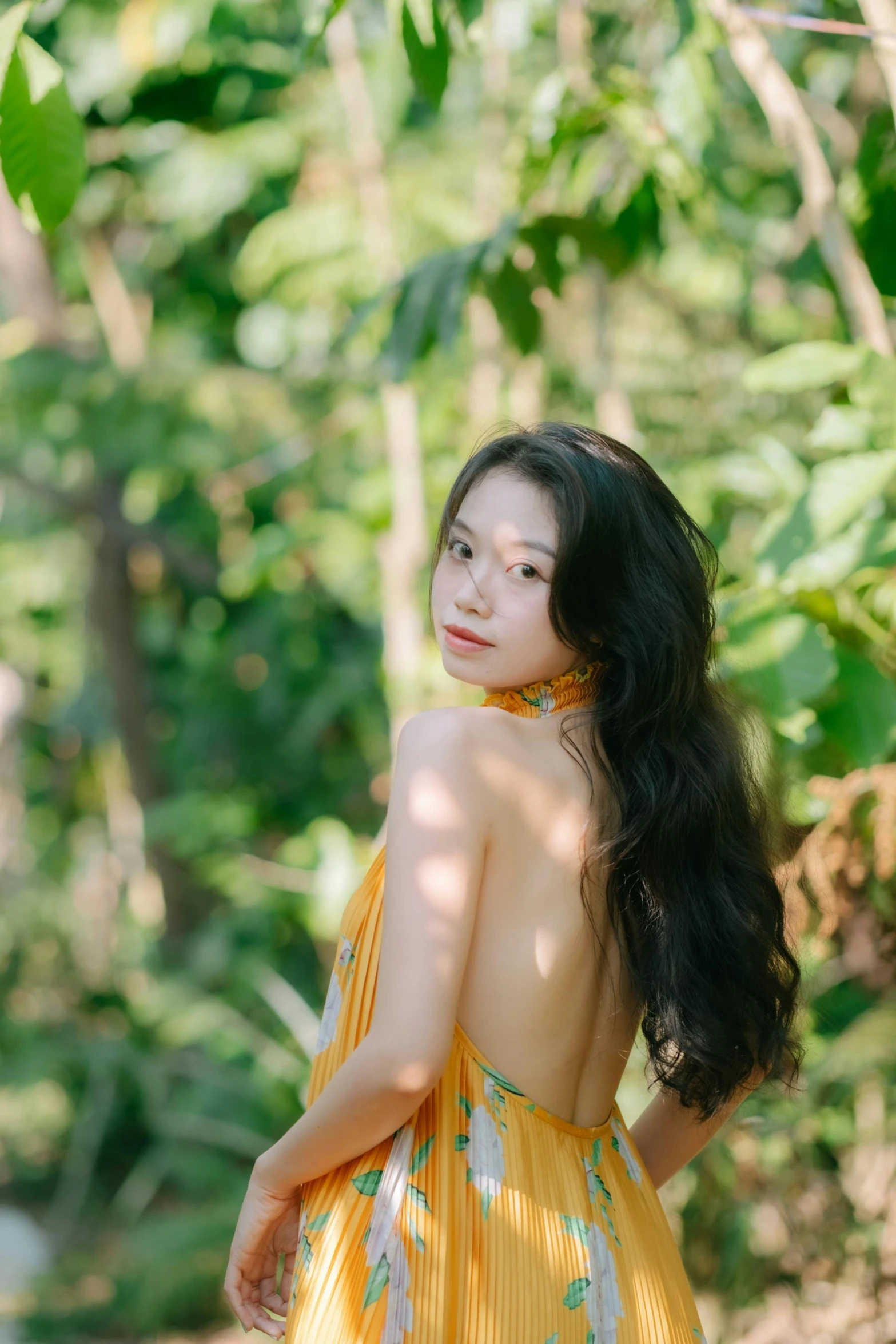 a beautiful woman in a yellow dress posing for a pograph