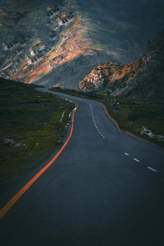 a long straight road runs through the mountains