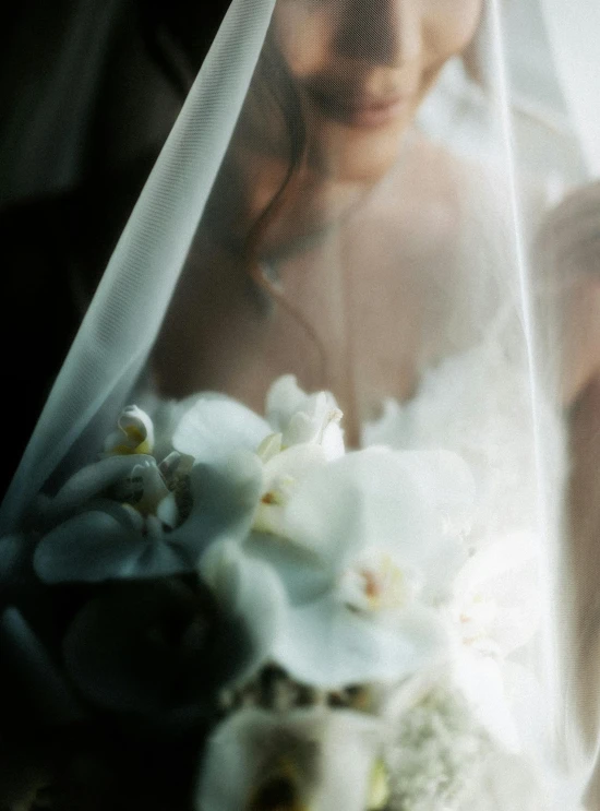 a person standing next to flowers and veil