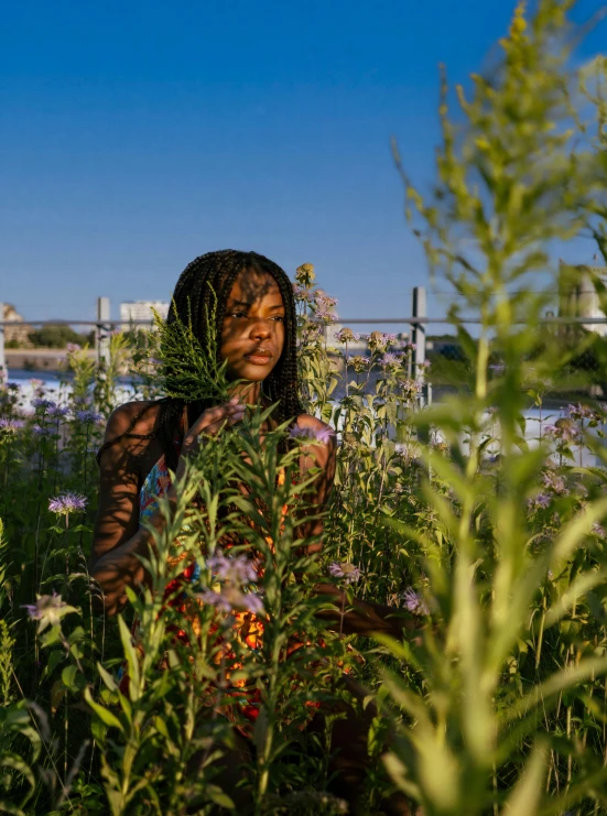 a woman with her face covered by plants