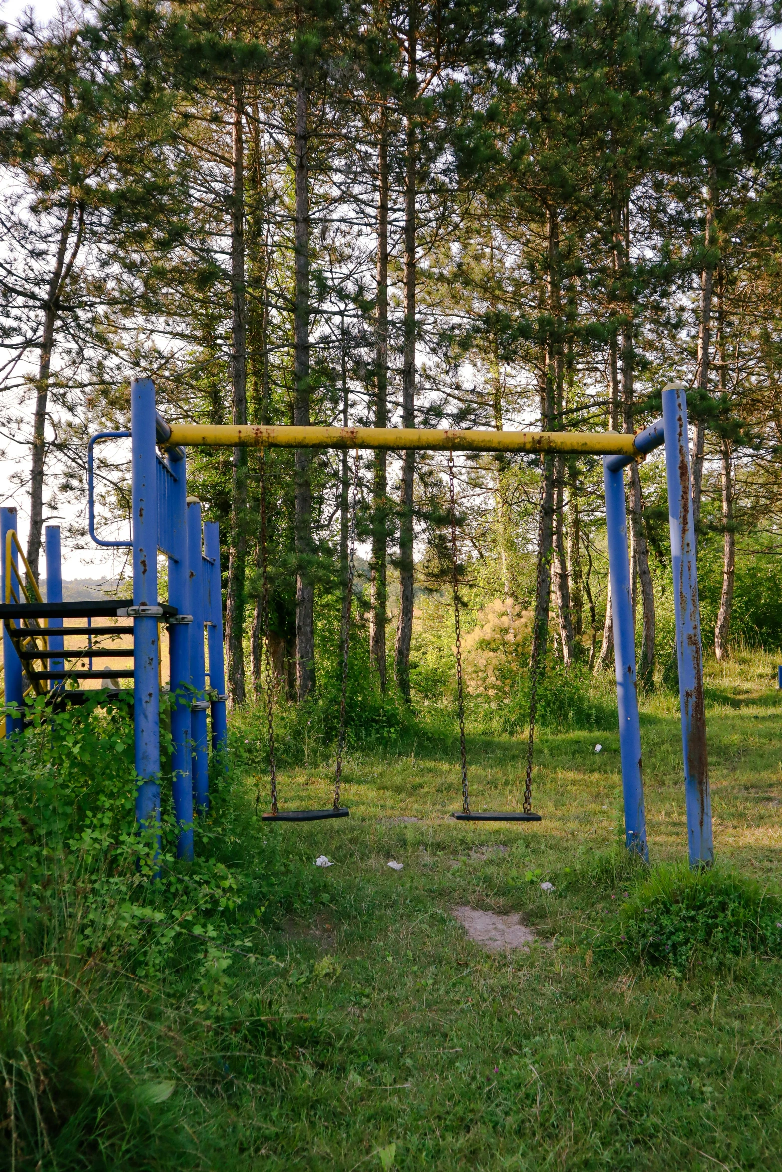 a metal structure near a park with trees