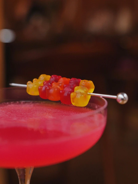 a pink cocktail with a spoon on the side