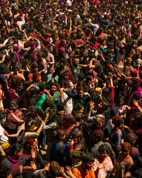 a crowd of people standing around each other at the festival