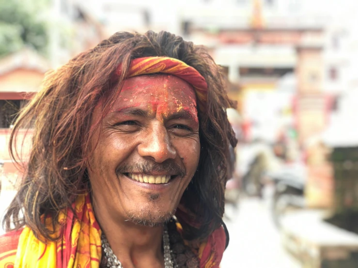 an indian man in the city with paint on his face