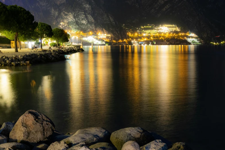 a city is seen lit up on the water