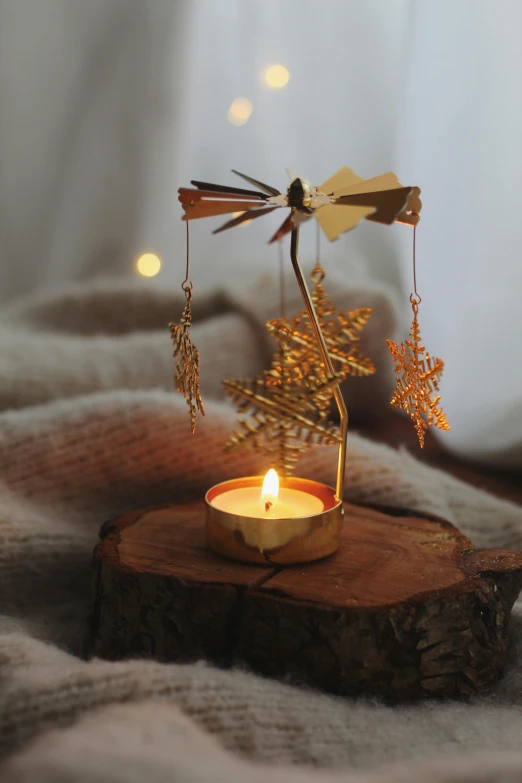 a candle and decoration on a wood piece