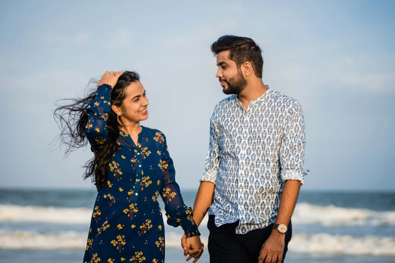 a couple on the beach looking at each other