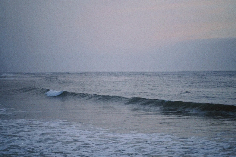 a surfer riding a wave at the beach