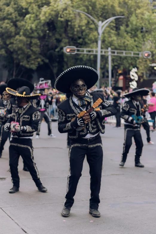 people in costumes and hats walking down the street